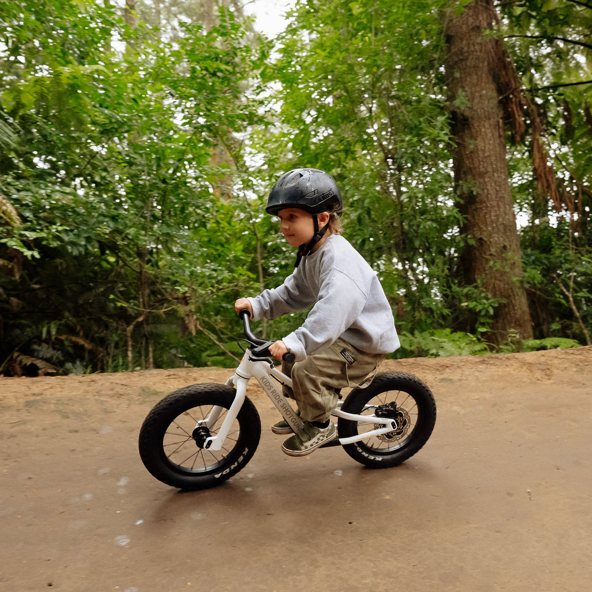 Niño en Dirt Hero balance bike en sendero de montaña